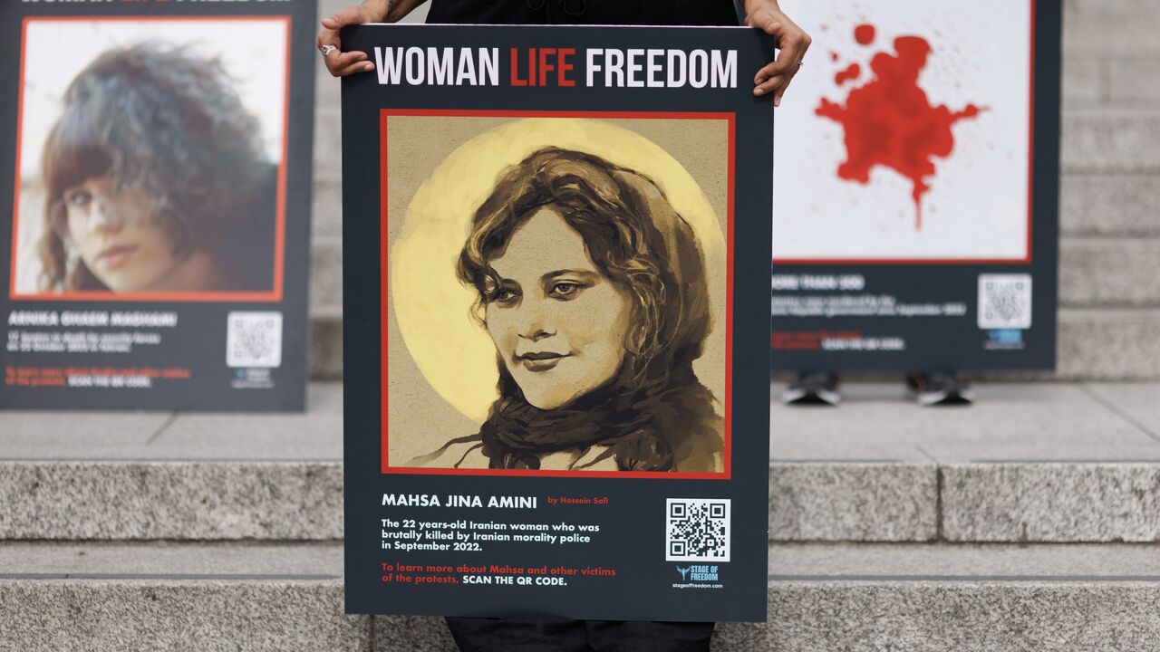 People take part in a protest in Trafalgar Square after marching through London ahead of the first anniversary of the death of Mahsa Amini, on September 13, 2023, in London, England.